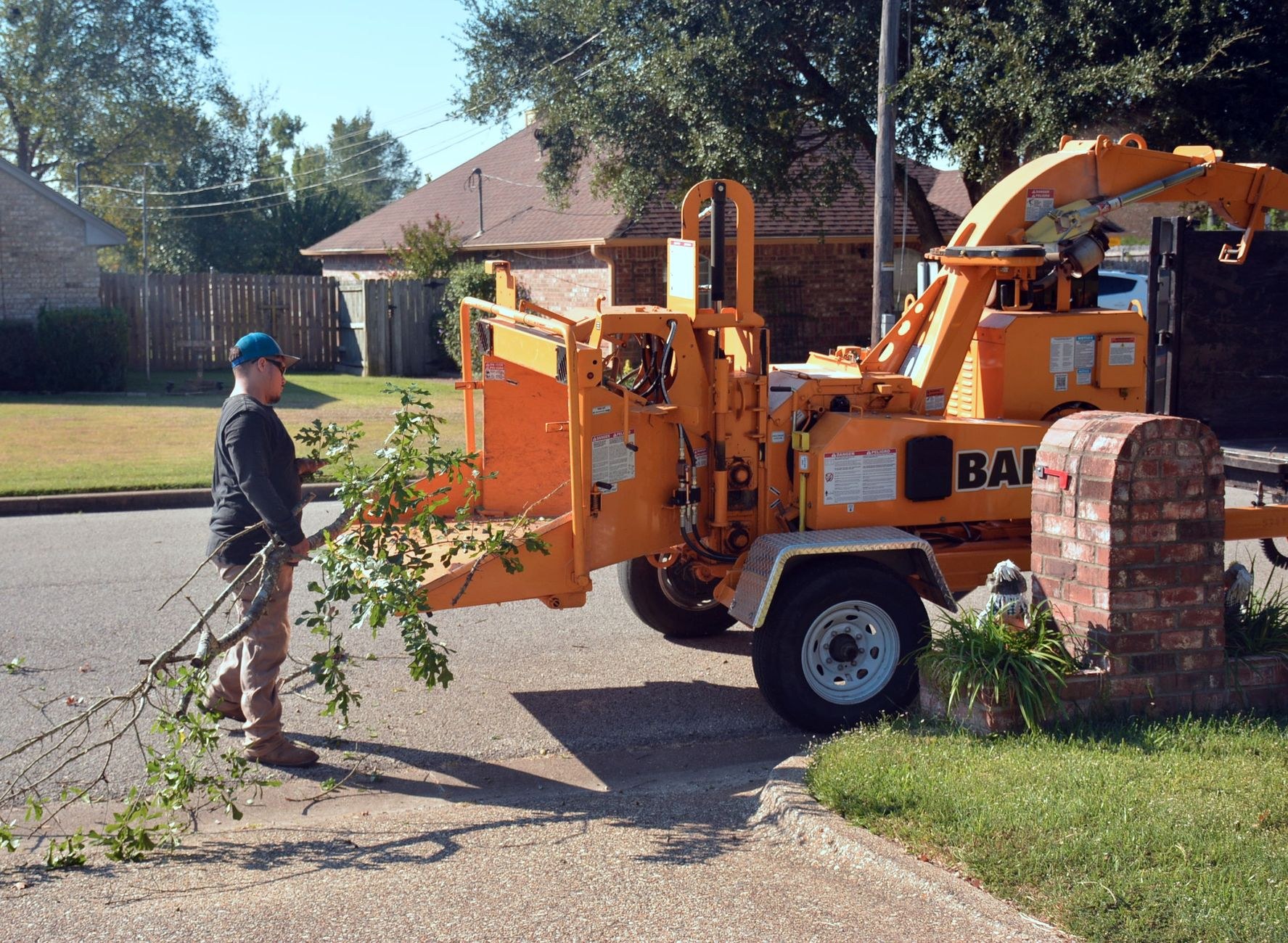 Wood chipper processing branches after a storm